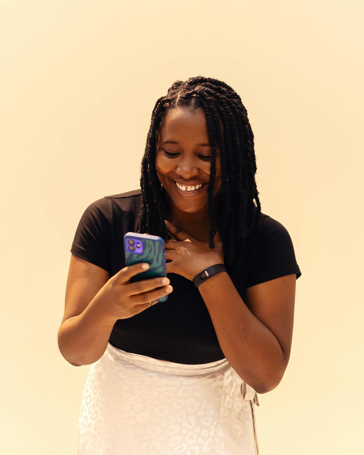 A merchant smiling while managing her business on WhatsApp